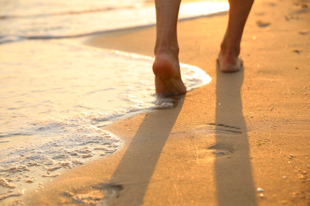 Man walking on sandy beach, closeup viewの写真素材