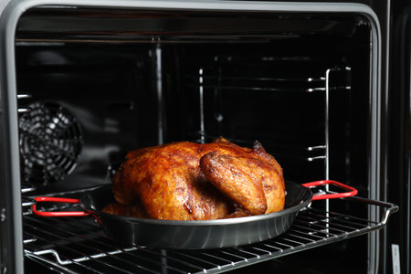 Delicious baked turkey in baking dish in ovenの写真素材