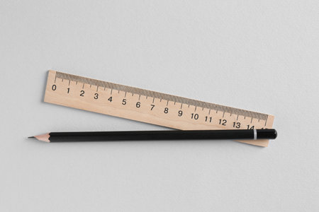 Ruler and pencil on light gray background, top viewの写真素材