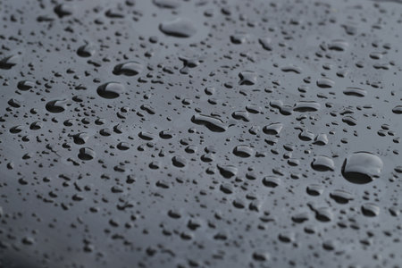 Water drops on grey glass surface, closeupの写真素材
