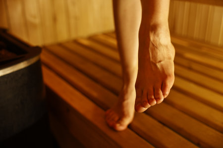 Young woman relaxing in hot sauna, closeup. Space for textの写真素材