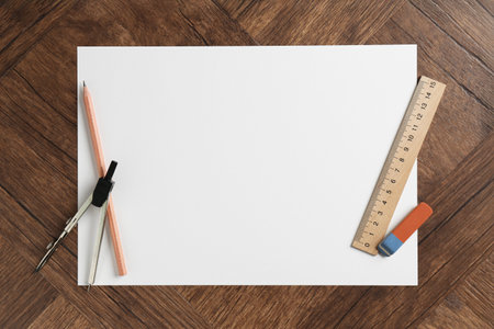 Ruler, paper, compass, eraser and pencil on wooden table, flat lay. Space for textの写真素材