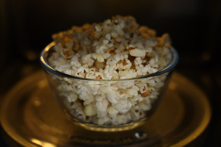 Bowl of popcorn in microwave oven, closeupの写真素材
