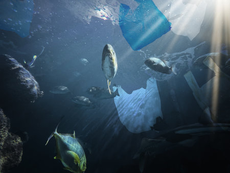 Environmental pollution. Ocean water with marine life and plastic garbage