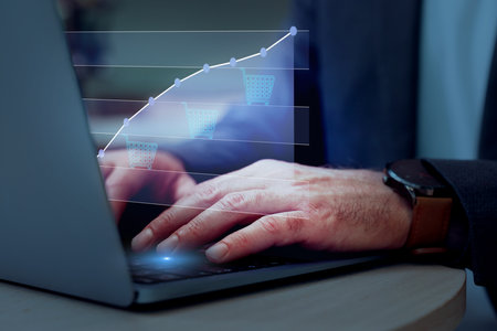 Man tracking price growth using laptop, closeup. Graph over device. Internet shopping conceptの写真素材