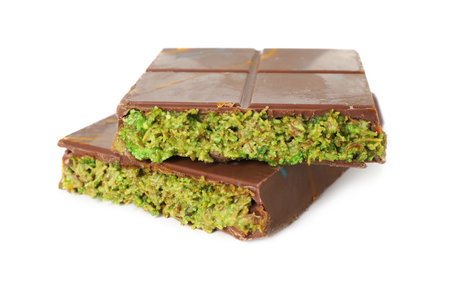 Pieces of chocolate bar with pistachio and knafeh isolated on whiteの写真素材