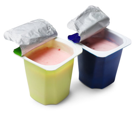 Delicious yogurts in plastic cups isolated on whiteの写真素材