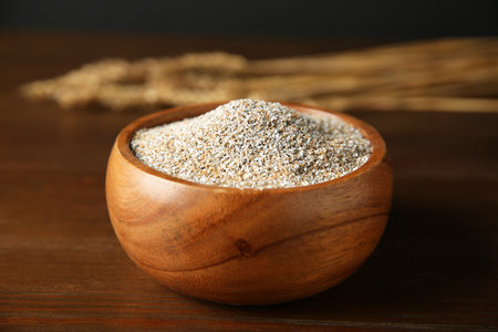 Fresh rye bran in bowl on wooden table, closeupの写真素材
