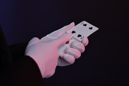 Illusionist with playing cards on dark background, closeupの写真素材