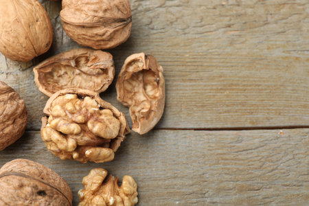 Fresh walnuts on wooden table, flat lay. Space for textの写真素材