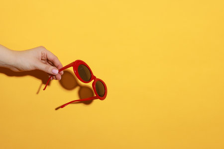 Woman with beautiful sunglasses on orange background, closeup and space for text. Stylish accessoryの写真素材