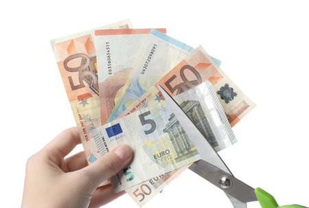 Woman cutting euro banknotes on white background, closeupの写真素材