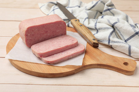 Tasty meat and knife on wooden table