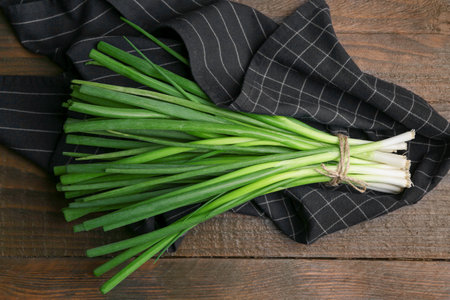 Bunch of fresh green onions on wooden table, top viewの写真素材