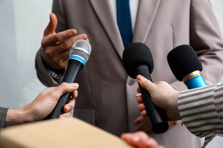Group of journalists interviewing businessman indoors, closeup