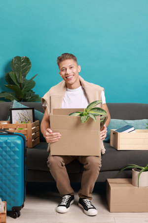 Happy man with different stuff in new apartment. Housewarming party