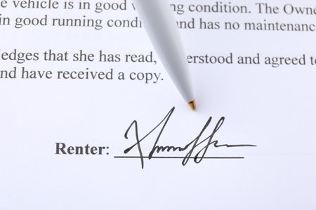 Signature and pen on paperwork, closeup view