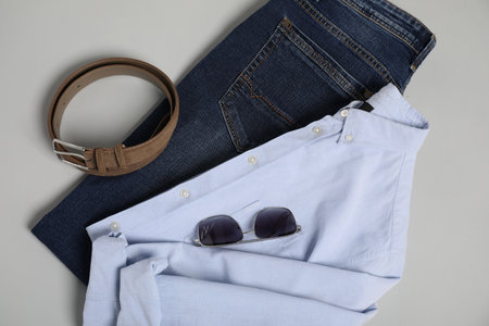 Stylish clothes and accessories on light grey background, flat layの写真素材