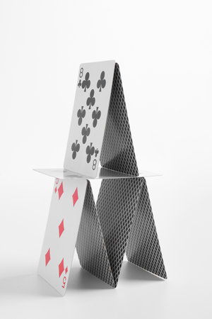 House of playing cards isolated on white