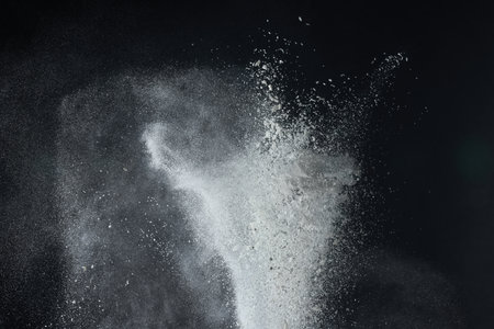 White snow falling down on black background