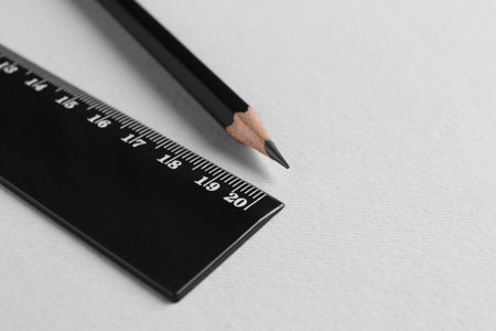Ruler and pencil on light grey background, closeup. Space for textの写真素材