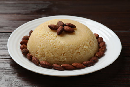 Delicious semolina halva with almonds on wooden tableの写真素材