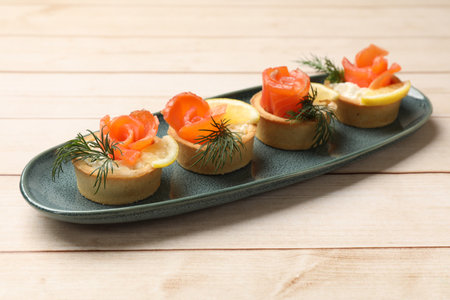 Tasty tartlets with delicious filling on wooden table, closeupの写真素材