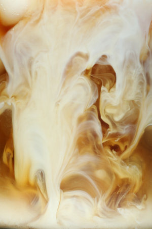 Refreshing coffee with ice and milk as background, closeupの写真素材