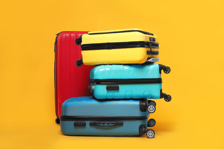 Many closed colorful suitcases on background