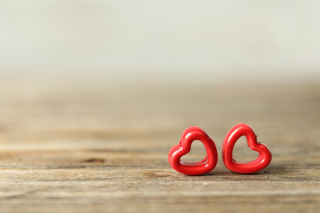 Red decorative hearts on wooden table, space for text. Happy Valentine's dayの写真素材