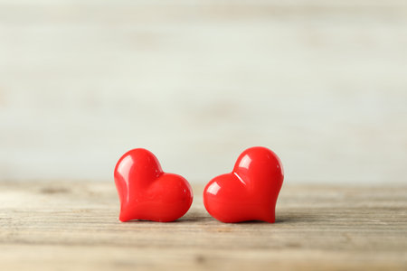 Red decorative hearts on wooden table, space for text. Happy Valentine's dayの写真素材
