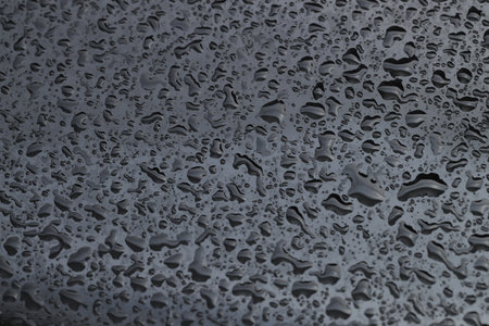 Water drops on grey glass surface, closeupの写真素材