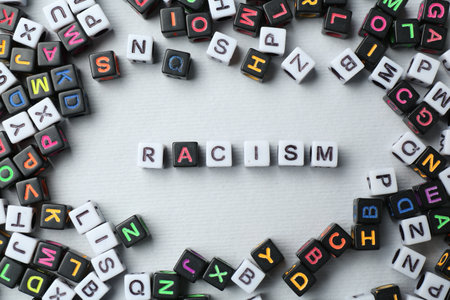 Word Racism and beads on light grey background, flat layの写真素材