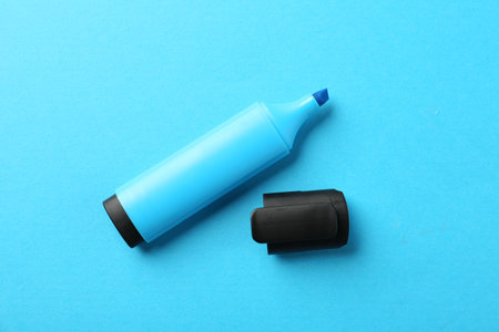 Bright highlighter and cap on light blue background, flat layの写真素材
