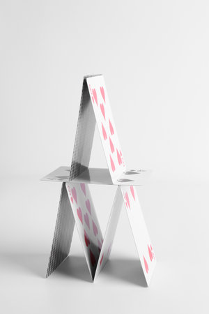 House of playing cards isolated on white