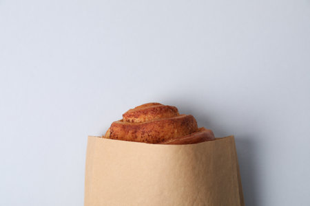 Paper bag with freshly baked bun on white background, top viewの写真素材