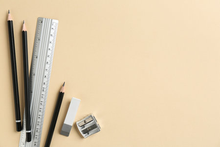 Flat lay composition with ruler and other stationery on beige background, space for textの写真素材