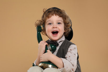Cute little boy with old telephone