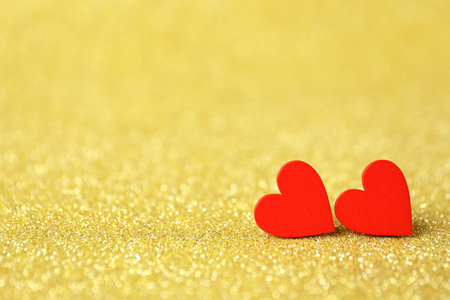 Red decorative hearts on shiny golden background, space for text. Happy Valentine's dayの写真素材