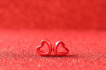 Decorative hearts on shiny red background, space for text. Happy Valentine's dayの写真素材