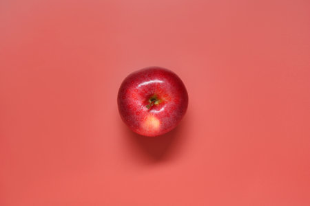 Fresh ripe apple on red background, top viewの写真素材