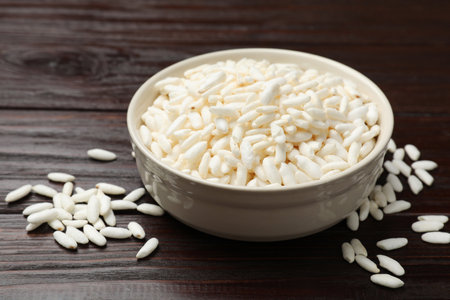 Puffed rice in bowl on wooden table, closeupの写真素材