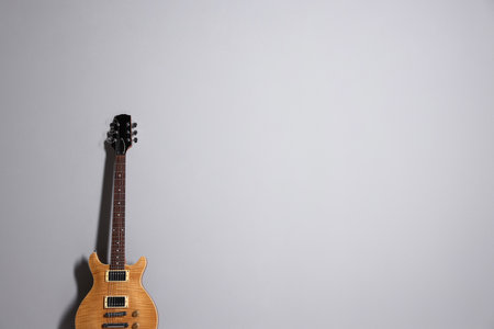 One modern electric guitar on light gray background. Space for textの写真素材