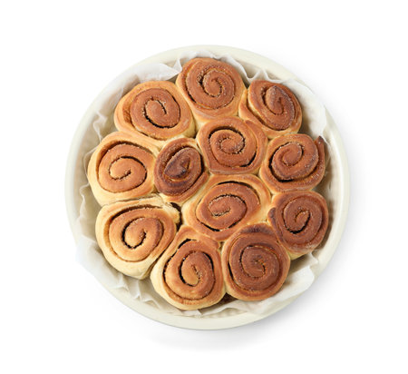 Freshly baked cinnamon rolls in baking dish isolated on white, top viewの写真素材