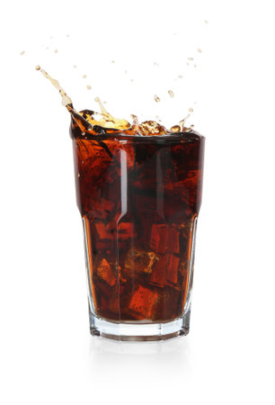 Refreshing cola with ice cubes splashing in glass isolated on whiteの写真素材