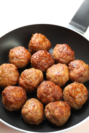 Tasty meatballs in frying pan on white table, closeupの写真素材