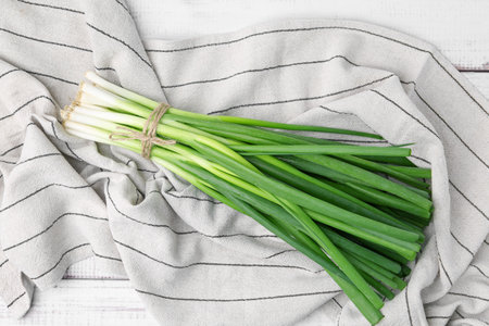 Bunch of fresh green onions on white table, top viewの写真素材