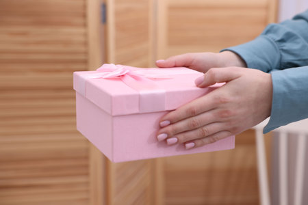 Woman with beautiful wedding gift indoors, closeupの写真素材