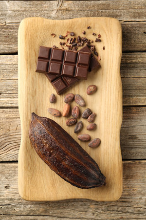 Cocoa pod, beans and chocolate on wooden table, top viewの写真素材