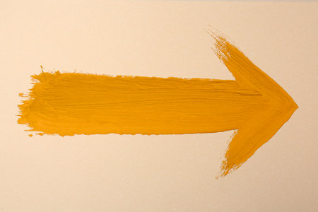 One orange arrow on beige background. Pointer